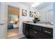 Modern bathroom featuring a granite countertop and an open view to main bedroom at 16061 Blue Wave Way, Clermont, FL 34714