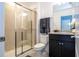 Bathroom featuring a walk-in shower, granite countertop, and a modern vanity at 16061 Blue Wave Way, Clermont, FL 34714