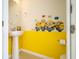 Charming powder room with fun Minion decor and a pedestal sink at 16061 Blue Wave Way, Clermont, FL 34714