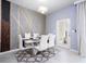 Chic dining area with modern table set for six, stylish accent wall, and contemporary lighting at 16061 Blue Wave Way, Clermont, FL 34714