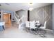Bright dining area featuring a modern table setting and staircase to the left at 16061 Blue Wave Way, Clermont, FL 34714