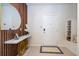Stylish foyer with marble console table, round mirror, decorative wood paneling, and neutral tile flooring at 16061 Blue Wave Way, Clermont, FL 34714