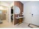 Foyer area featuring a stylish console table, wooden accents, and a glimpse into the shower and primary bedroom at 16061 Blue Wave Way, Clermont, FL 34714