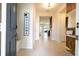 Bright and inviting foyer featuring neutral tile, welcome sign, and decorative accents at 16061 Blue Wave Way, Clermont, FL 34714