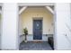 Stylish front door with a dark blue finish, modern hardware, and a welcoming entrance at 16061 Blue Wave Way, Clermont, FL 34714