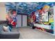 Fun Mario-themed game room with comfortable sofa and a large television for entertainment at 16061 Blue Wave Way, Clermont, FL 34714
