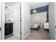 Hallway view leading to a cozy bedroom, featuring a unique accent wall and calming atmosphere at 16061 Blue Wave Way, Clermont, FL 34714