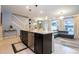 This kitchen island features granite countertops, and stainless steel appliances, with easy access to the living area at 16061 Blue Wave Way, Clermont, FL 34714