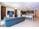 This open-concept living room boasts modern decor, a large TV, and seamless access to the kitchen at 16061 Blue Wave Way, Clermont, FL 34714
