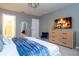 Inviting main bedroom with a fireplace, chic furnishings, and a glimpse of the en-suite bathroom at 16061 Blue Wave Way, Clermont, FL 34714