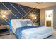 Stunning main bedroom with modern accent wall, stylish lighting, and luxurious bed at 16061 Blue Wave Way, Clermont, FL 34714