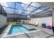 Beautiful backyard featuring a private screened in pool, with comfortable lounge chairs at 16061 Blue Wave Way, Clermont, FL 34714