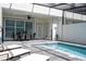 Inviting pool area with lounge chairs, dining table and a screened enclosure for year-round enjoyment at 16061 Blue Wave Way, Clermont, FL 34714