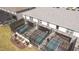 A beautiful aerial view showing off the screened in in-ground pools and patios of these townhomes at 16061 Blue Wave Way, Clermont, FL 34714