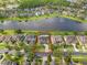 A beautiful aerial view of the property with a lake view and a screened in pool in the back at 16120 Bristol Lake Cir, Orlando, FL 32828
