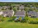 A peaceful aerial view of the back of the property with a lush green lawn and screened in pool at 16120 Bristol Lake Cir, Orlando, FL 32828