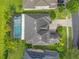 An aerial view of the property highlighting the pool and verdant backyard and roof at 16120 Bristol Lake Cir, Orlando, FL 32828