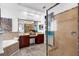 Bathroom featuring a double vanity, tub, walk-in shower with tile surround, and neutral color palette at 16120 Bristol Lake Cir, Orlando, FL 32828