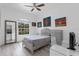 Comfortable bedroom with window views, gray accent furniture and a stylish ceiling fan at 16120 Bristol Lake Cir, Orlando, FL 32828