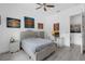 Bedroom with a comfortable bed, desk, paintings and gray accent furniture at 16120 Bristol Lake Cir, Orlando, FL 32828