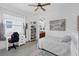 Bedroom with a comfortable bed, desk, bookcase and paintings at 16120 Bristol Lake Cir, Orlando, FL 32828