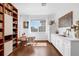Eat-in kitchen featuring modern white cabinets, wood floors, and bright natural light at 16120 Bristol Lake Cir, Orlando, FL 32828