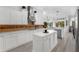 Modern kitchen featuring white cabinetry, stainless steel appliances, an island, and neutral backsplash at 16120 Bristol Lake Cir, Orlando, FL 32828