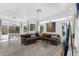 Inviting living room with grey hardwood floors, comfortable seating, a chandelier, and bright natural light at 16120 Bristol Lake Cir, Orlando, FL 32828