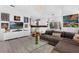 Open living room featuring modern decor, a grey sectional sofa, and seamless flow to other rooms at 16120 Bristol Lake Cir, Orlando, FL 32828
