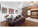 Spacious living room featuring custom bookshelves, sleek floors, and a cozy leather sofa at 16120 Bristol Lake Cir, Orlando, FL 32828