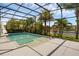 Relaxing screened-in pool area with tropical landscaping and serene water views at 16120 Bristol Lake Cir, Orlando, FL 32828