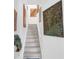 Bright stairway with art pieces adorning the walls leading to the upper level of this lovely home at 16120 Bristol Lake Cir, Orlando, FL 32828