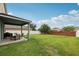 The backyard features a covered patio and a large green space at 16440 Centipede St, Clermont, FL 34714