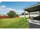 This large backyard includes a covered patio and green lawn at 16440 Centipede St, Clermont, FL 34714