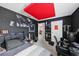 This bedroom features dark walls, a red ceiling panel, and shelving at 16440 Centipede St, Clermont, FL 34714