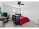 Bright bedroom with large window, carpeted floors, desk and red bed at 16440 Centipede St, Clermont, FL 34714