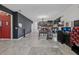 Open-concept living area with tile floors, dark accent wall, and view of kitchen and dining space at 16440 Centipede St, Clermont, FL 34714