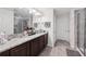 Ensuite bathroom featuring a double vanity with granite countertops and a walk-in shower at 16440 Centipede St, Clermont, FL 34714