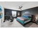 Spacious main bedroom with dark accent wall, king bed and neutral carpeted floors at 16440 Centipede St, Clermont, FL 34714