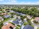 The aerial view reveals a vibrant neighborhood with tree-lined streets and a harmonious blend of homes and nature at 201 Hammock Dunes Pl, Orlando, FL 32828