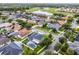 An aerial view of a community with well-maintained homes, yards and a lake at 201 Hammock Dunes Pl, Orlando, FL 32828