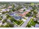 Aerial view of a residential neighborhood featuring homes with swimming pools and mature trees at 201 Hammock Dunes Pl, Orlando, FL 32828