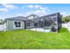 A sprawling backyard features a large screened-in pool and plenty of green space at 201 Hammock Dunes Pl, Orlando, FL 32828