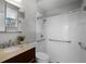 Clean bathroom featuring a sink, toilet, shower and safety bars offering accessibility and functionality at 201 Hammock Dunes Pl, Orlando, FL 32828