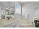 Elegant bathroom featuring a jacuzzi tub, double vanity, and a well-lit vanity area at 201 Hammock Dunes Pl, Orlando, FL 32828