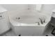 Close-up of the modern bathtub featuring chrome fixtures and jets at 201 Hammock Dunes Pl, Orlando, FL 32828