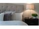 Bedroom featuring plush pillows on a bed, side table, and a lamp offering a comfortable retreat at 201 Hammock Dunes Pl, Orlando, FL 32828