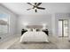 Cozy bedroom featuring a plush bed, ceiling fan, and abundant natural light at 201 Hammock Dunes Pl, Orlando, FL 32828