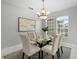 Formal dining room with modern chandelier, seating for six, and neutral decor at 201 Hammock Dunes Pl, Orlando, FL 32828
