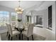 Formal dining room with modern chandelier, seating for six, and neutral decor at 201 Hammock Dunes Pl, Orlando, FL 32828